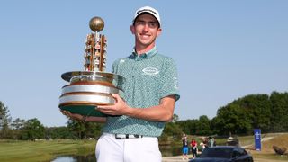 Man holding golden trophy smiling