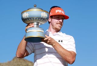 Golfer with championship trophy