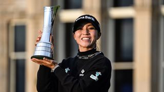 Woman holds business achievement trophy