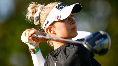 Woman golfer in white sun hat