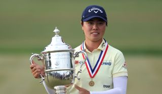 Asian woman celebrates with trophy