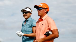 Couple golfing on course together