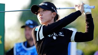 Woman golfer in putting stance