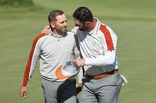 Two golfers on putting green