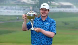 Man with silver sports trophy