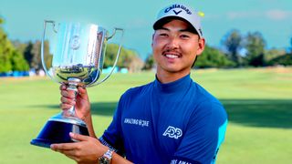 Man holding golden sports trophy