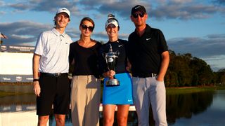 Golfers celebrate with championship trophy