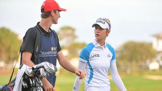 Couple playing golf on course