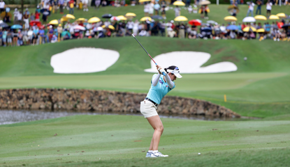 Woman golfing outdoors