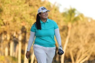 Woman walking golf course