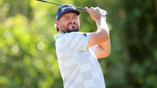 Golfer swinging at driving range