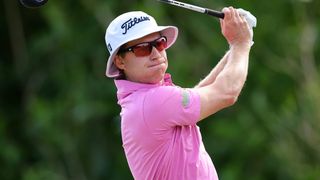 Pink-shirted golfer mid-swing