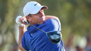 Golfer swinging in blue shirt